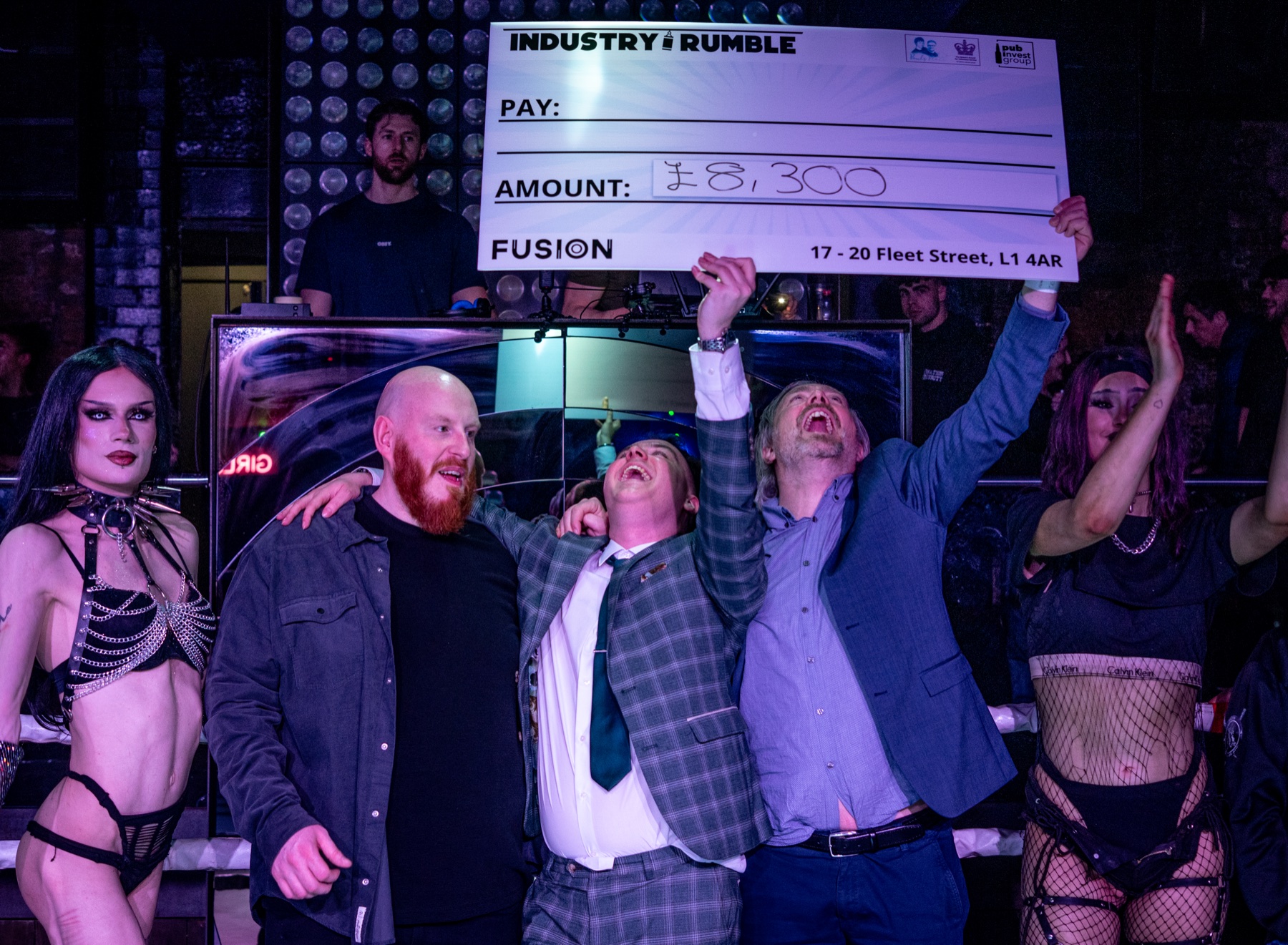 Industry Rumble team celebrating a charity cheque presentation