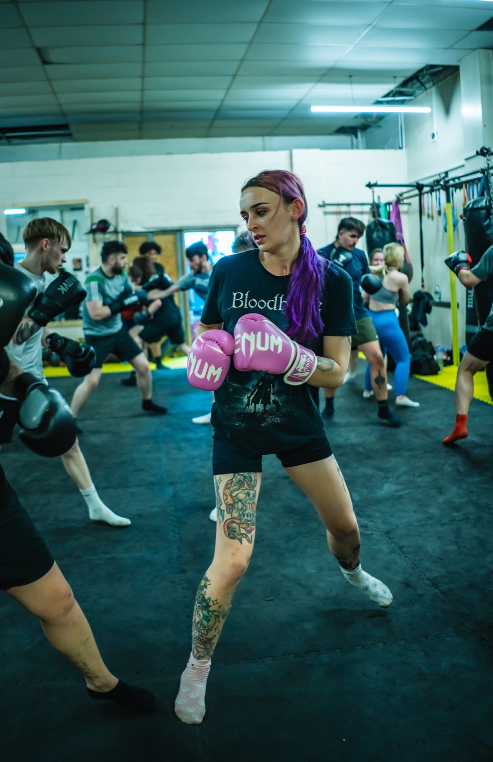 Industry Rumble participant training with pink boxing gloves