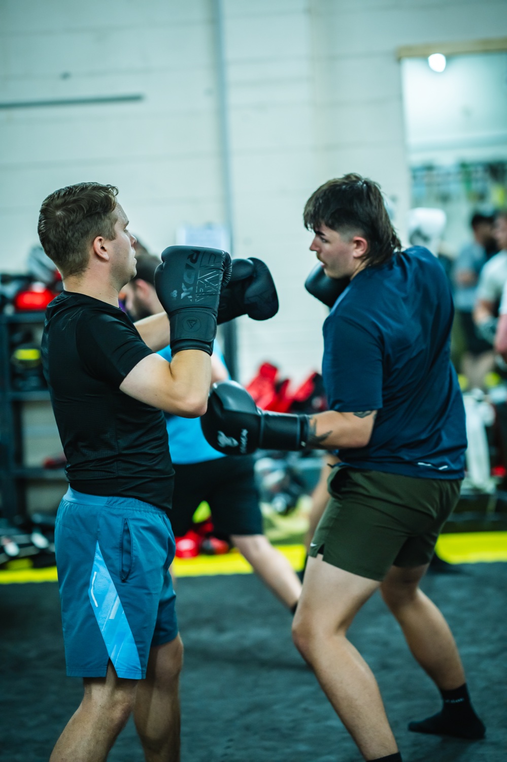 Industry Rumble participants practising pad work during training